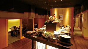 A buffet setup with various dishes and a decorative centerpiece.