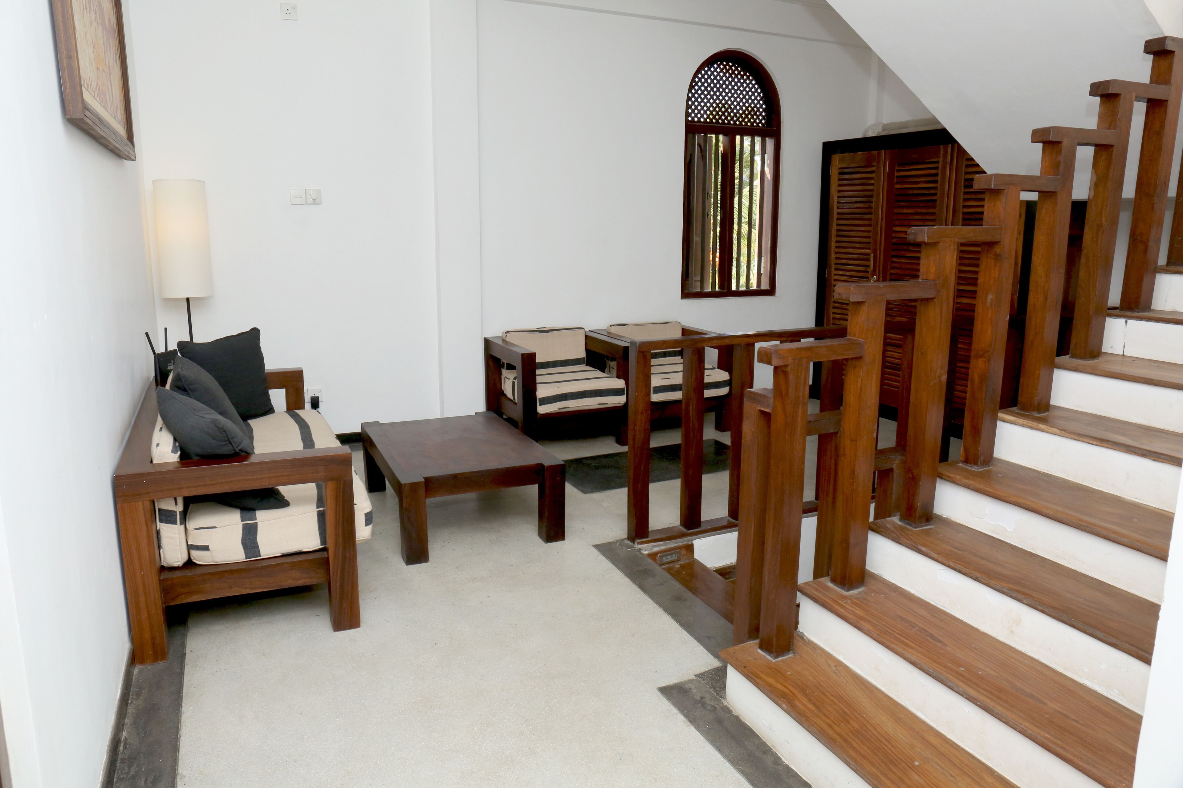A staircase with wooden railings leading to a landing.
