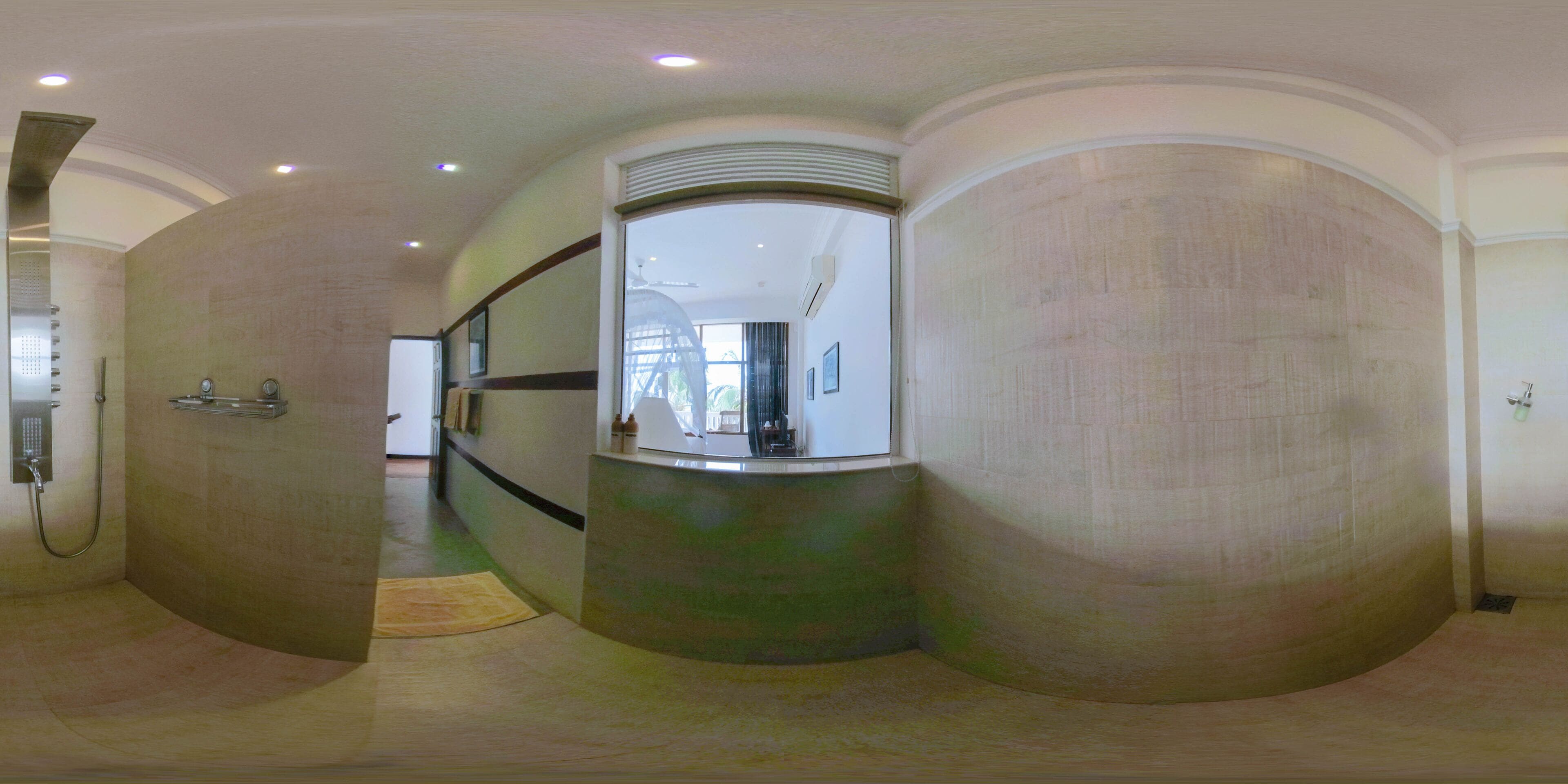 A curved hallway with a shower area on the left, a reception desk in the center, and a large mirror reflecting the room.