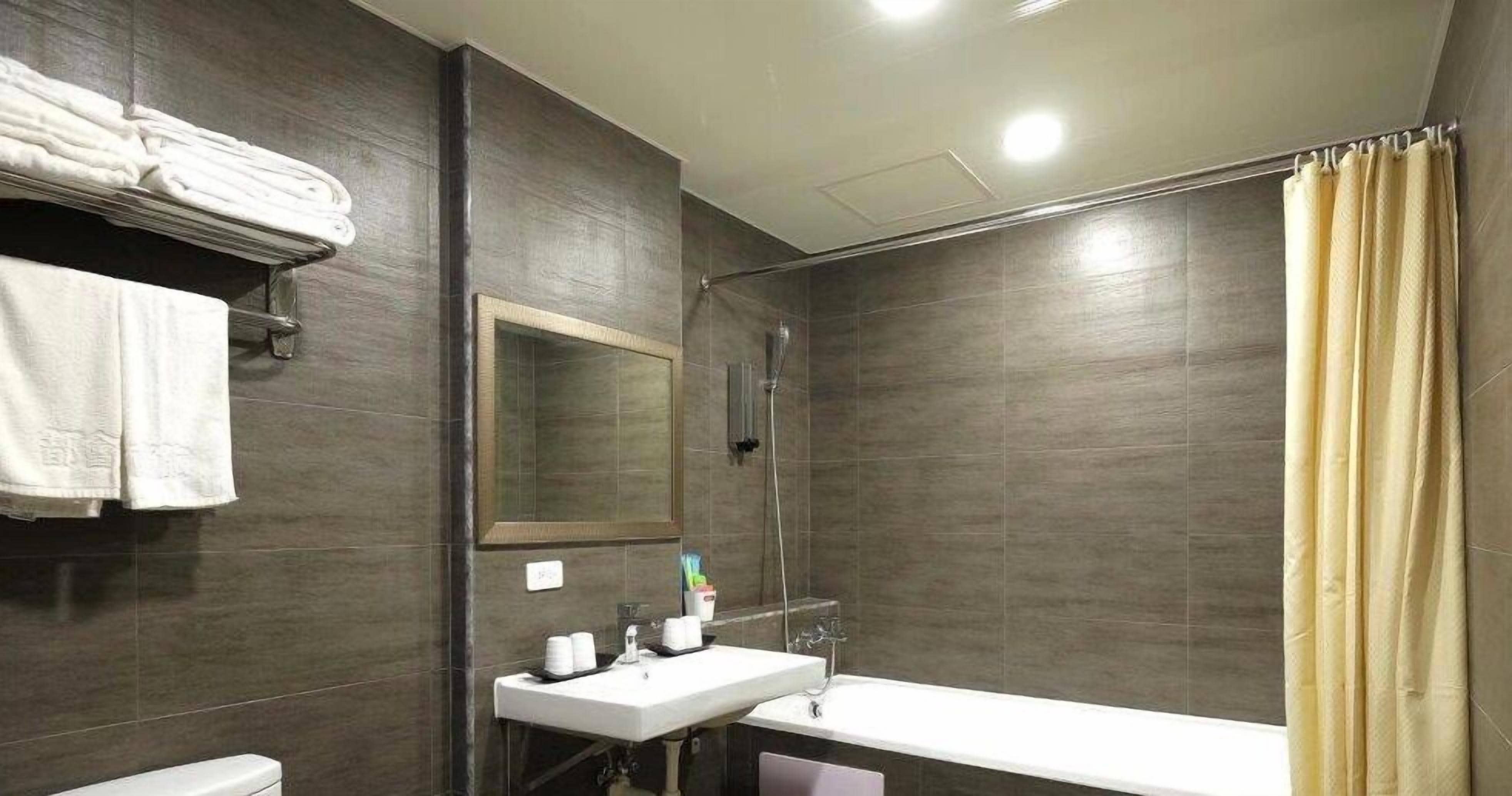 deluxe quadruple room | bathroom | shower, free toiletries, hair dryer, slippers