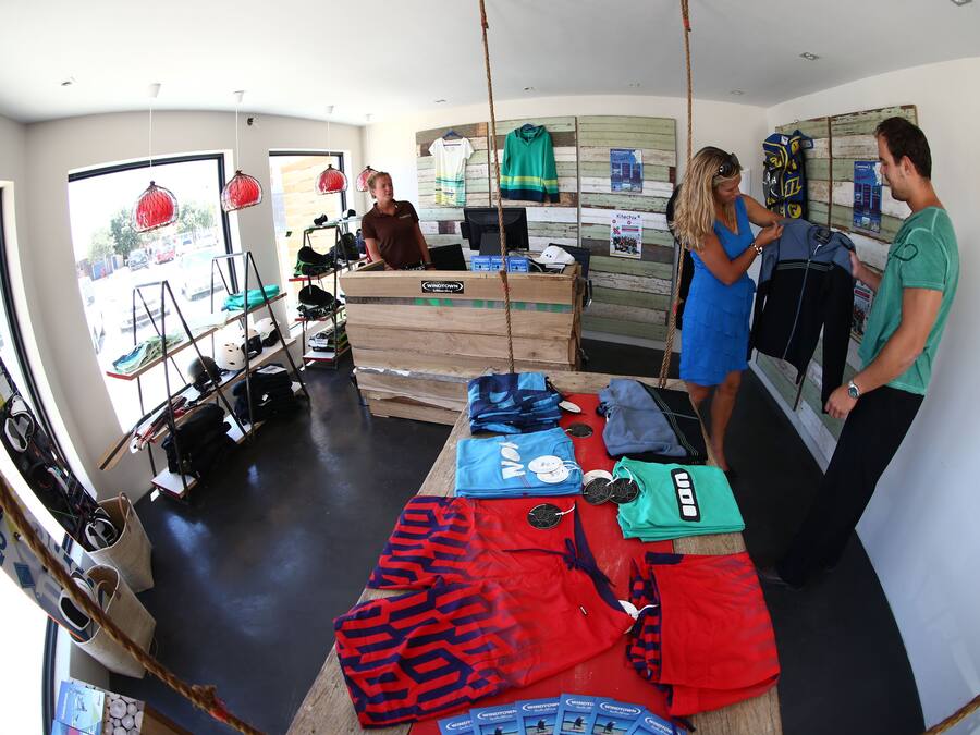 A room with a large window, a reception desk, and various sports equipment.