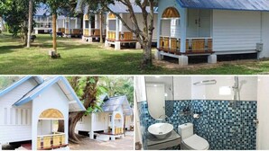 A series of white cabins with blue roofs, each featuring a porch and a small deck. - PAN Beachfront Resort Krabi (Krabi)