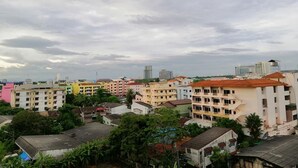 A residential area with multi-story buildings, some with balconies, under a cloudy sky. - W Apartment Hat Yai (Hat Yai)