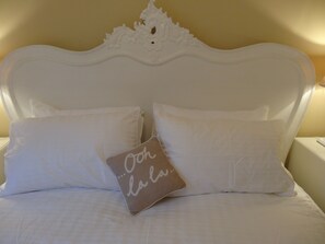 A bed with white bedding and two pillows, one with a message. - Brighton Break - Burlington Beach Pad (Brighton)