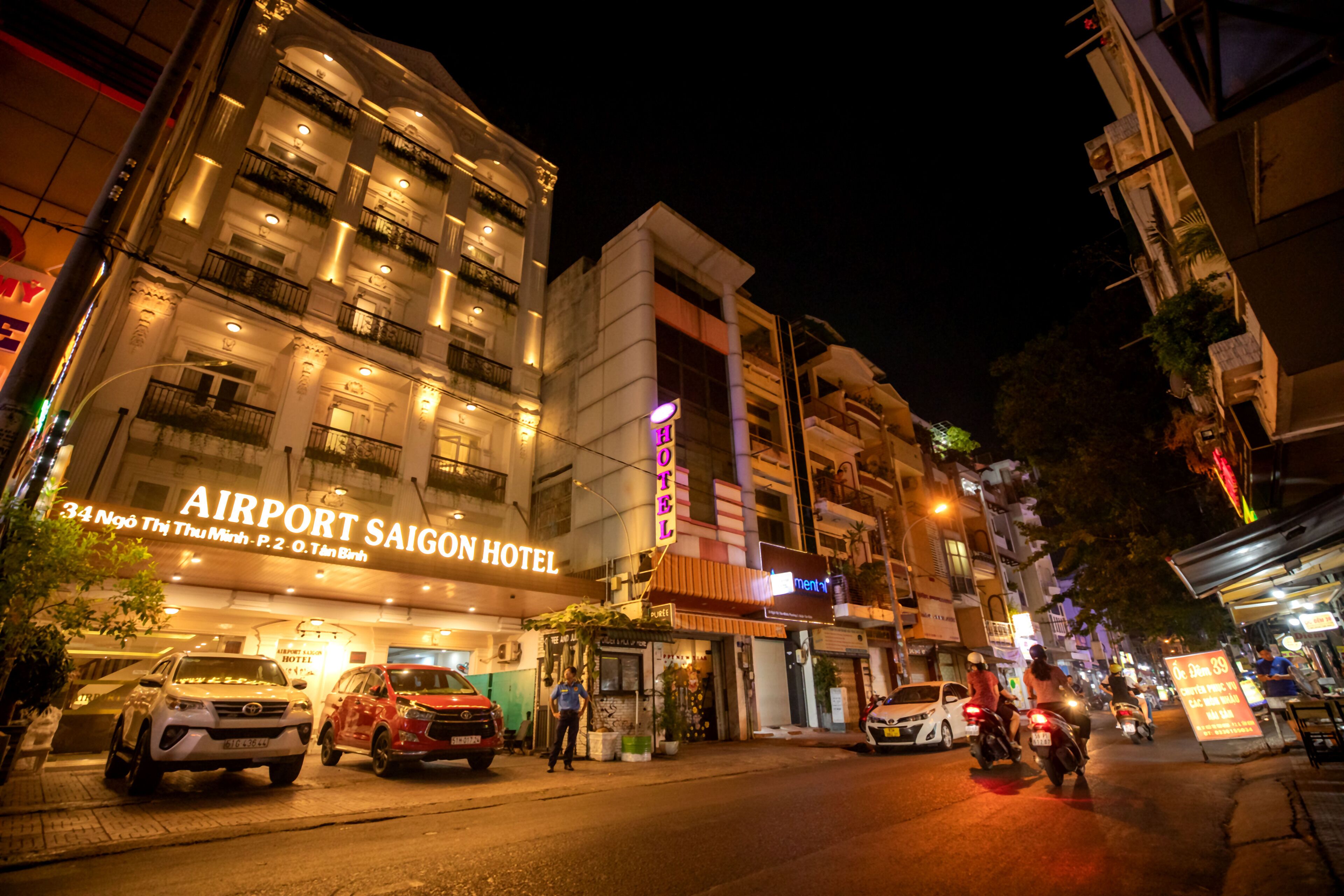 The exterior of the Airport Saigon Hotel with a sign indicating it is a hotel.