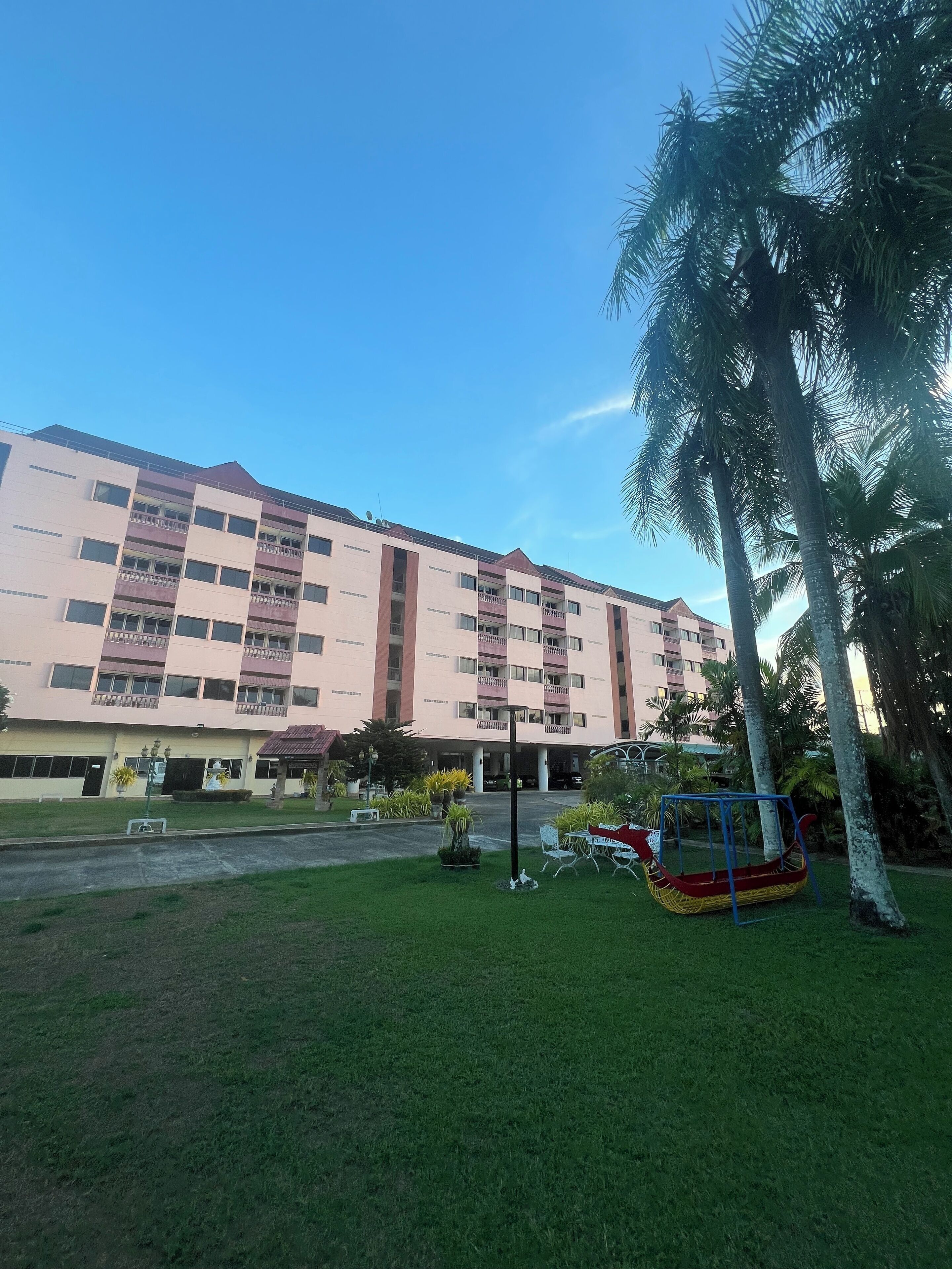 A multi-story hotel with a flat roof and balconies.