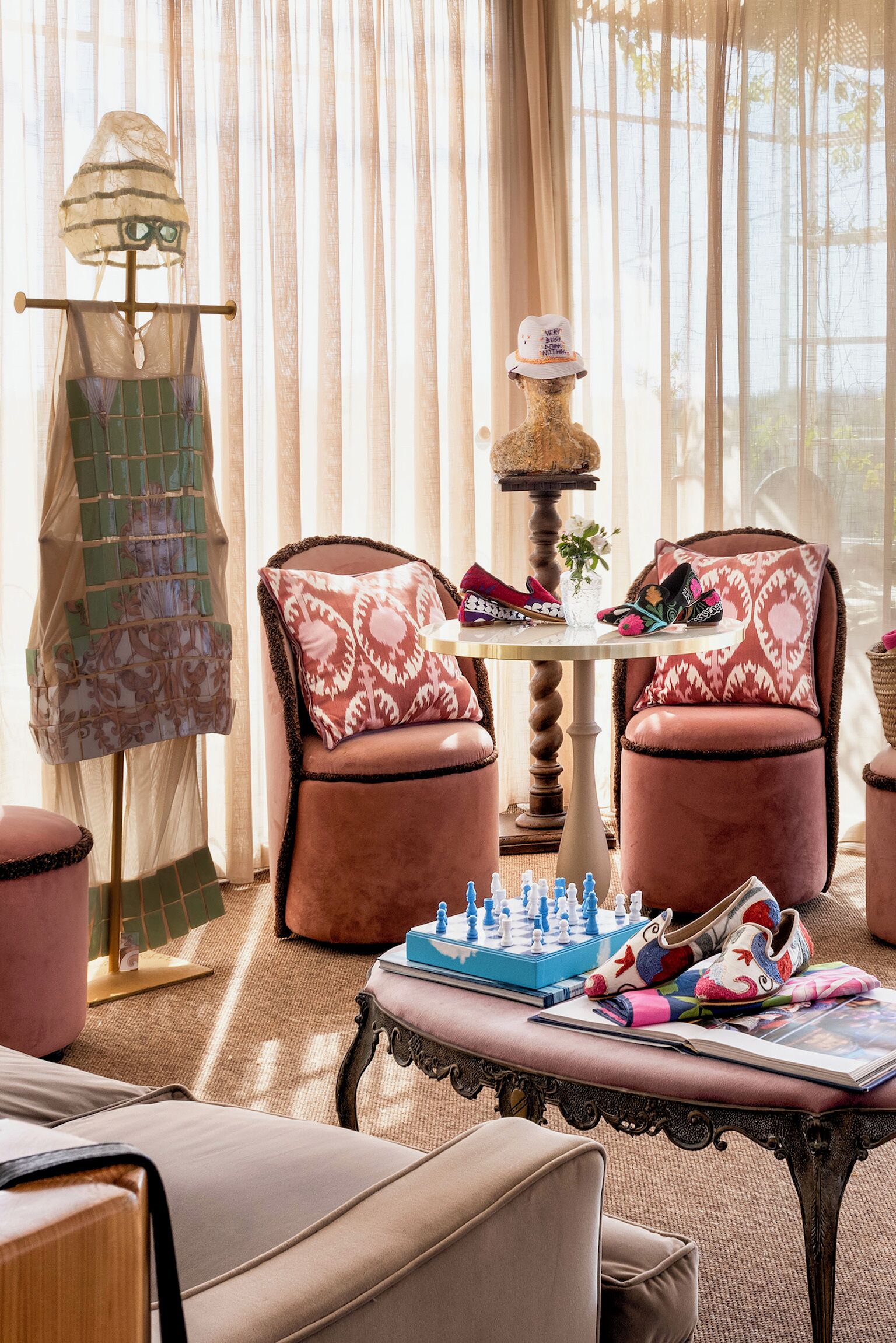 A cozy room with a chessboard, a mannequin with a hat, and a table with shoes and a book.