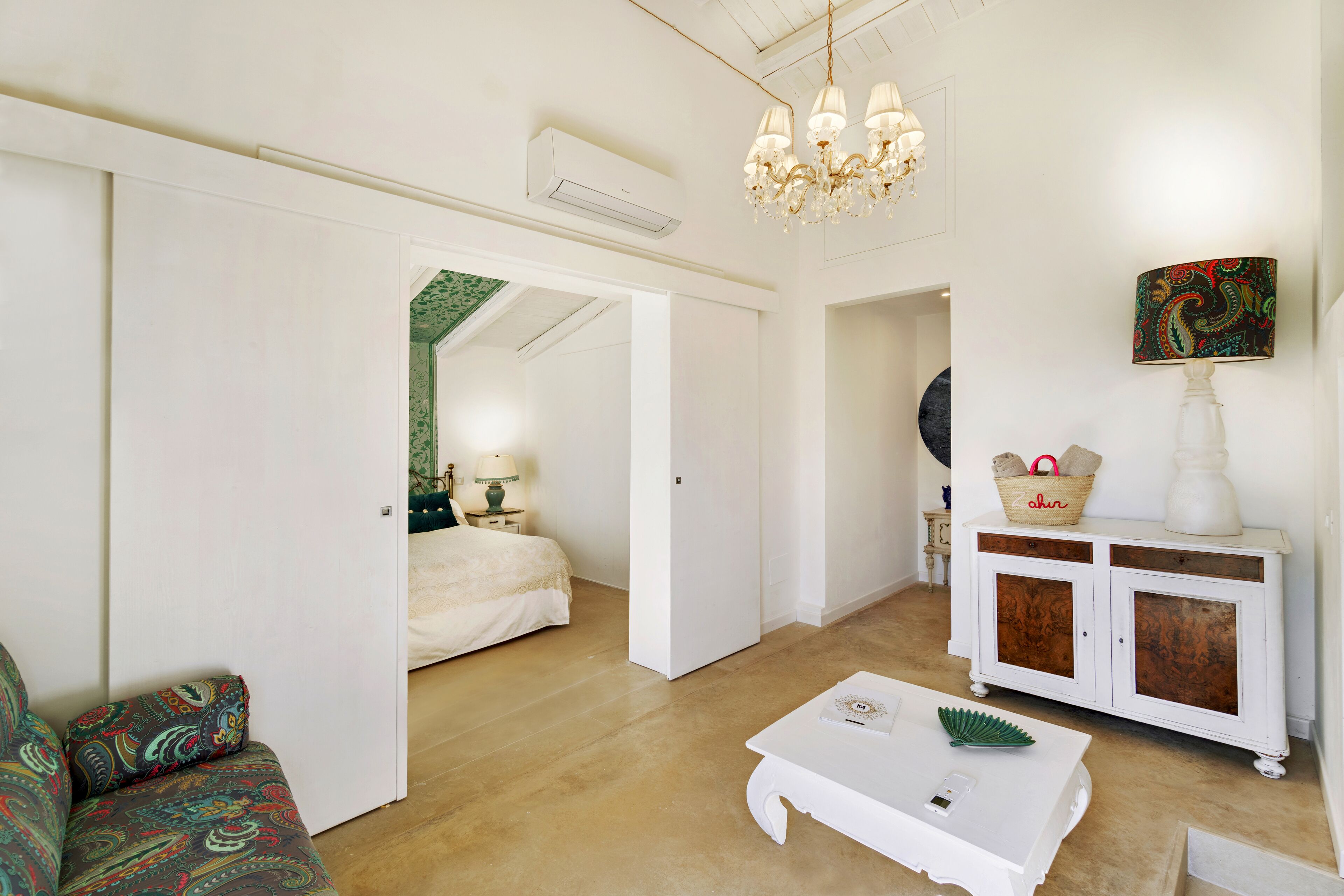 A spacious living room with a sofa, a coffee table, and a cabinet.