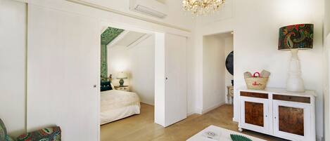 A spacious living room with a sofa, a coffee table, and a cabinet.