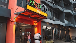 A building with a large panda statue outside, a sign reading "ecentio Style", and a person taking a photo. - Recenta Style Phuket Town (Phuket)