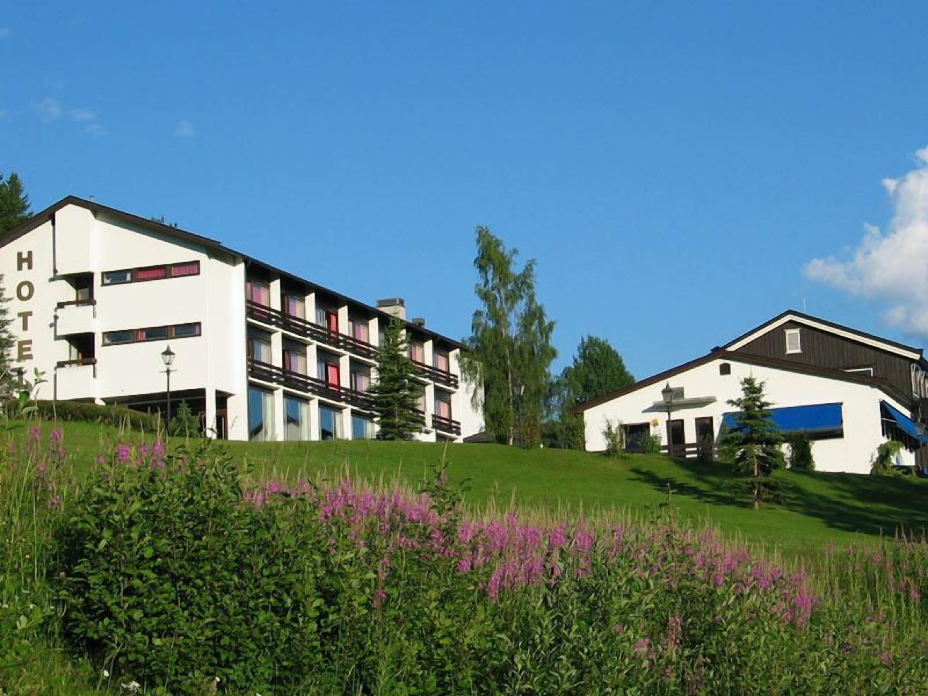 Hotel com design moderno, com varandas e telhado plano.