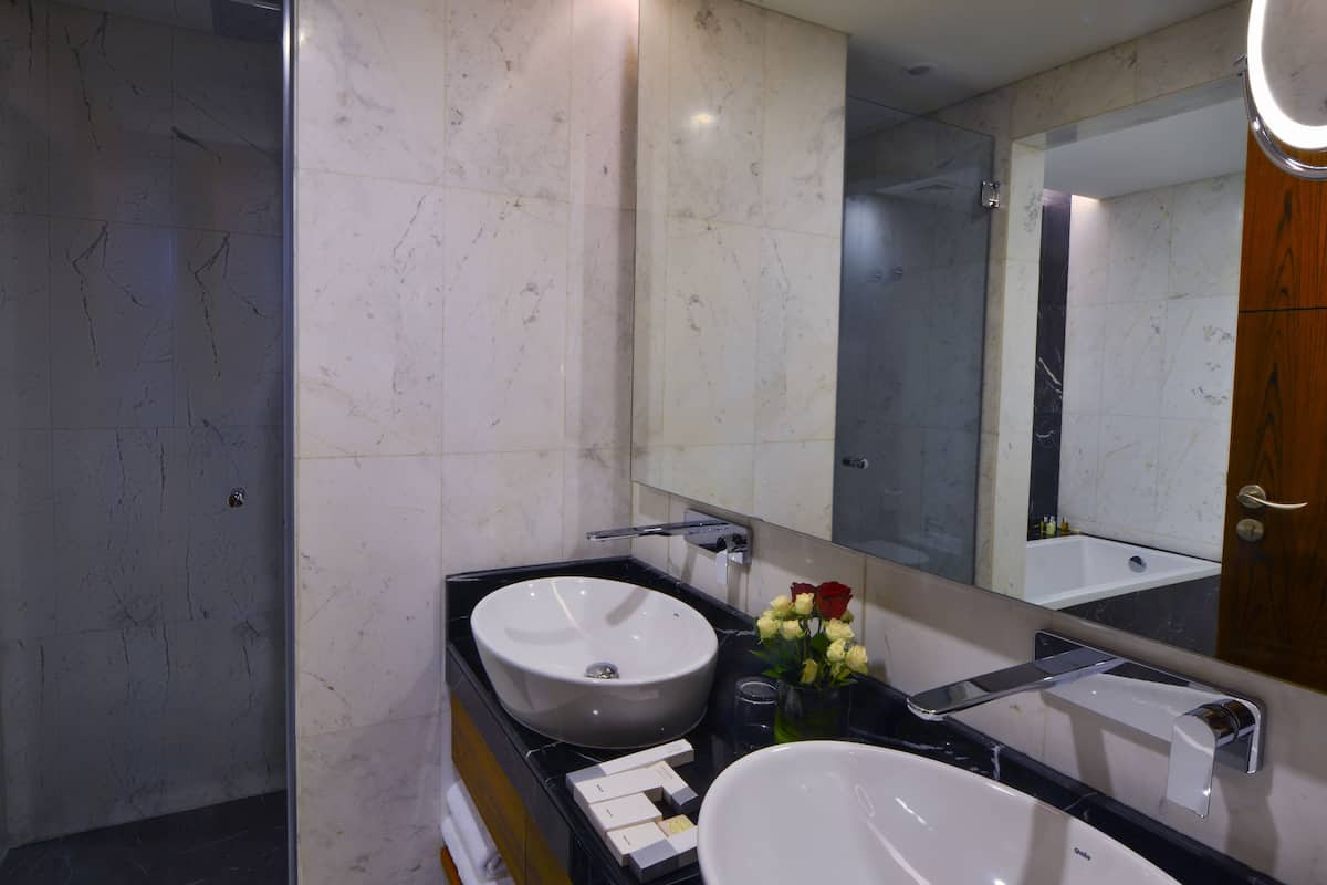 deep-soaking bathtub, rainfall showerhead, designer toiletries