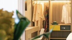 A modern hotel room with a wooden wardrobe, a bed, a desk, and a chair. - Hotel Hollywood (Rimini)