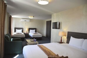 Triple Room | Minibar, in-room safe, desk, iron/ironing board - Olive Hotel (Amman)