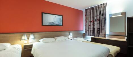 A hotel room with a large bed, two bedside tables with lamps, a headboard, a wall-mounted picture, and a window with curtains.