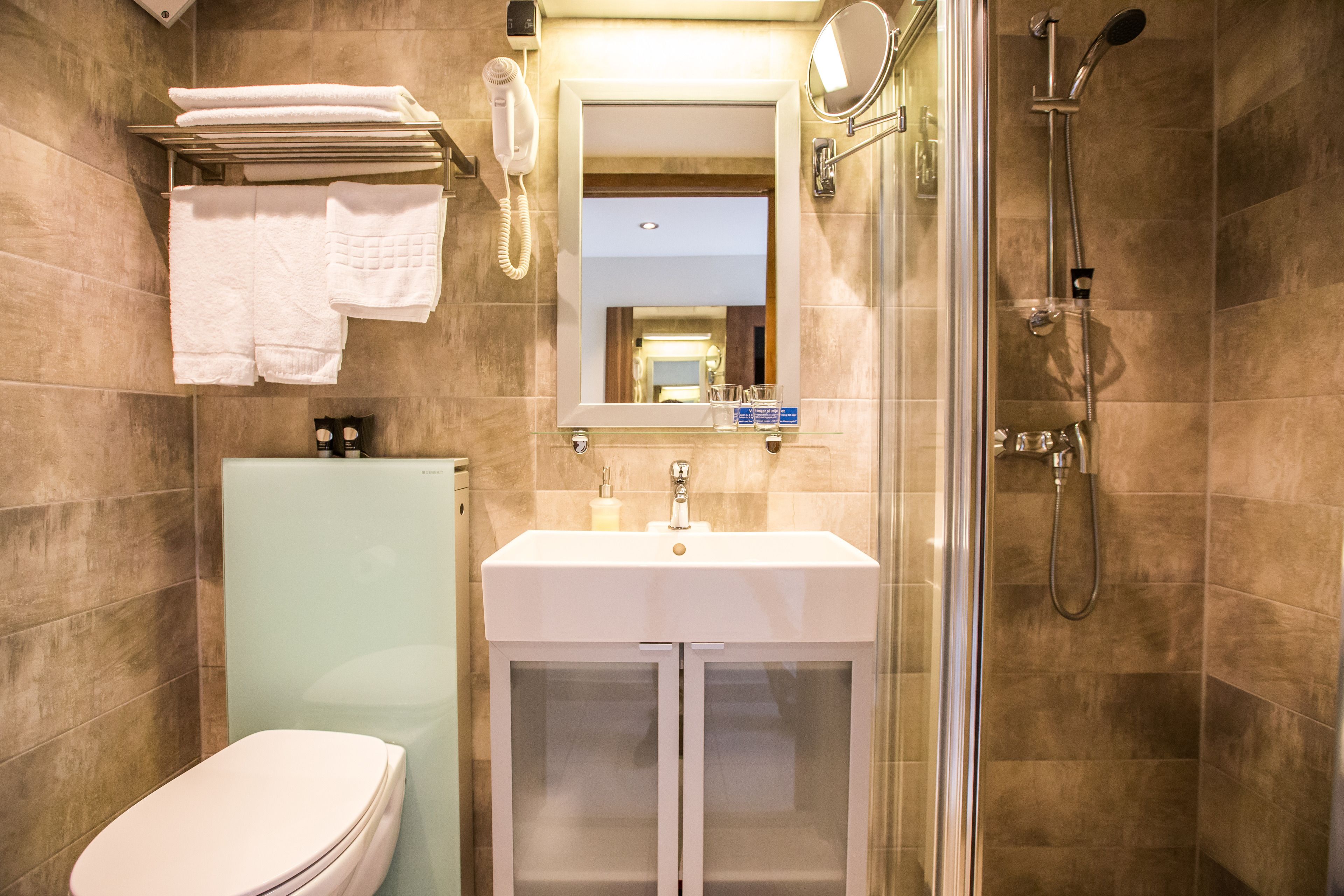 Ein Badezimmer mit Toilette, Waschbecken und Dusche.