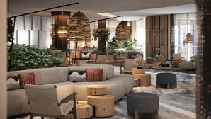 A modern lounge area with a sofa, chairs, and wooden side tables. - Four Points by Sheraton Sunny Beach (Sunny Beach)