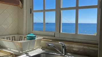 Deluxe Apartment, 1 Bedroom, Kitchenette, Ocean View | Private kitchen | Full-sized fridge, microwave, stovetop, cookware/dishes/utensils