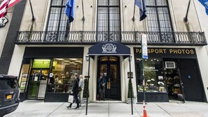 A building with a large entrance, flags, and a sign for "The Men's National Republican Club". - 3 West Club (New York)