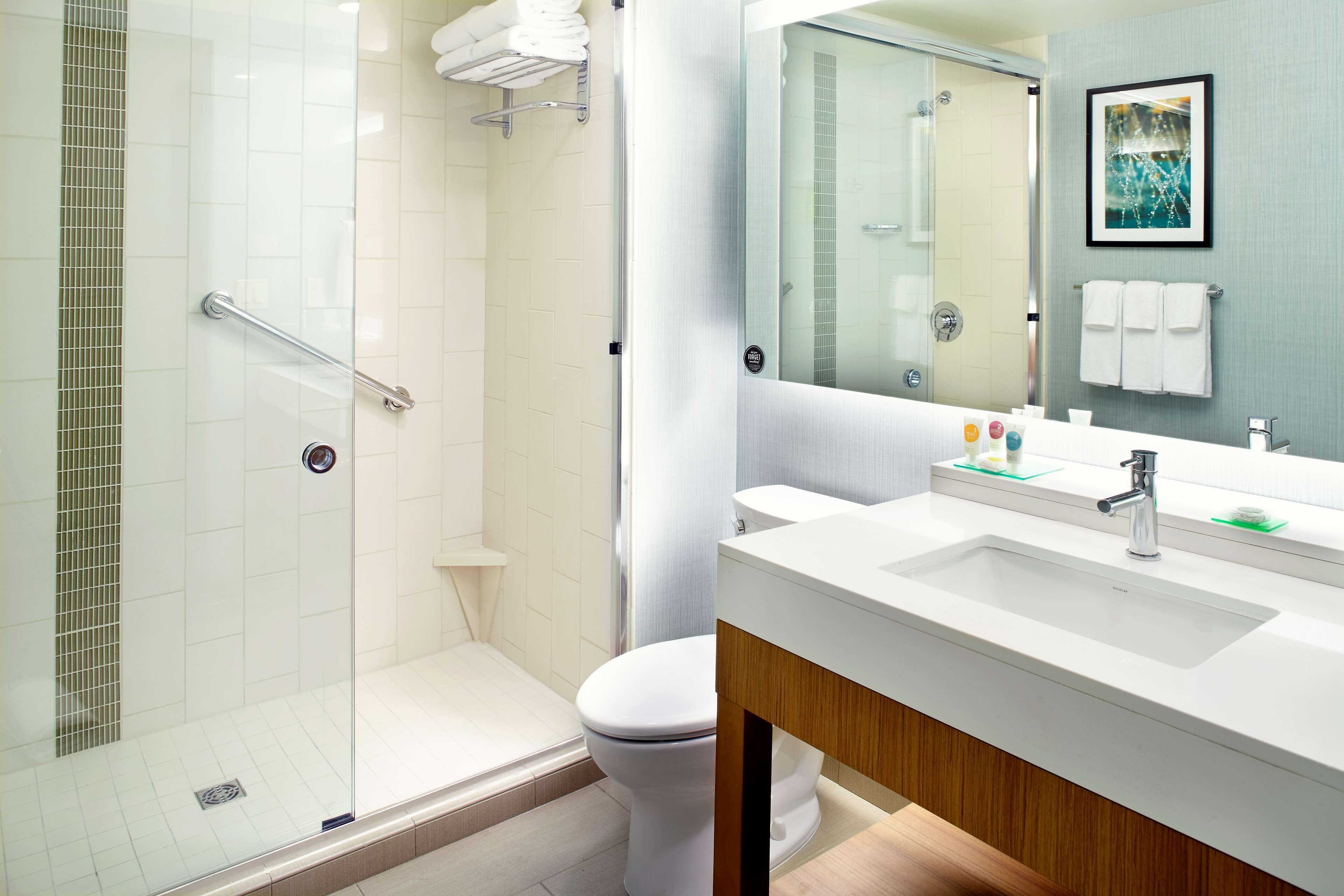 designer toiletries, hair dryer, towels