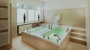 Een moderne badkamer met een vrijstaand bad, een raam met zonwering en een radiator.