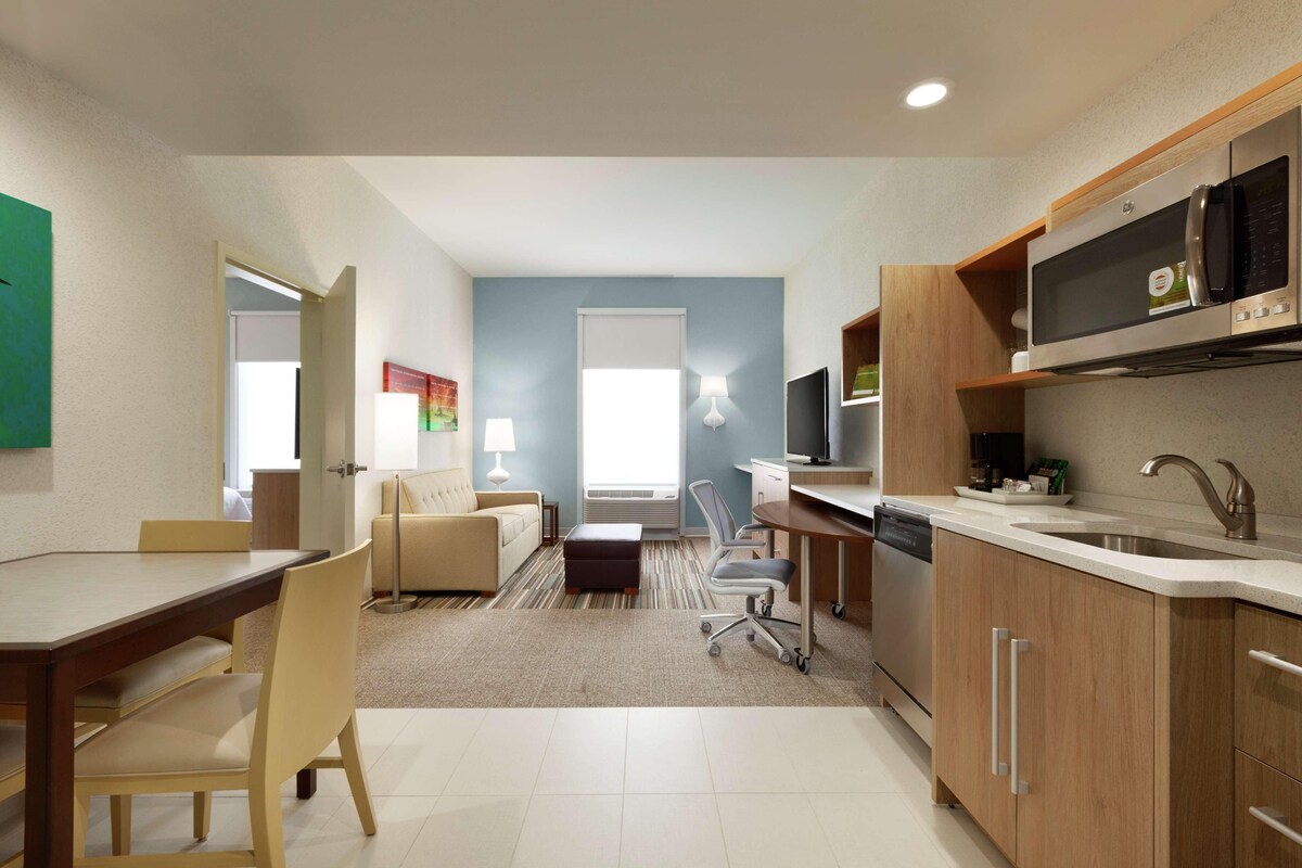 Una cocina moderna con comedor, sofá y televisión.