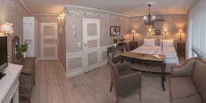 A hotel room with a bed, a desk, a chair, a TV, and a dresser. - Landhotel Kern (Bad Zwesten)