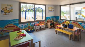 A brightly colored children's playroom with a slide, play mats, and various toys.