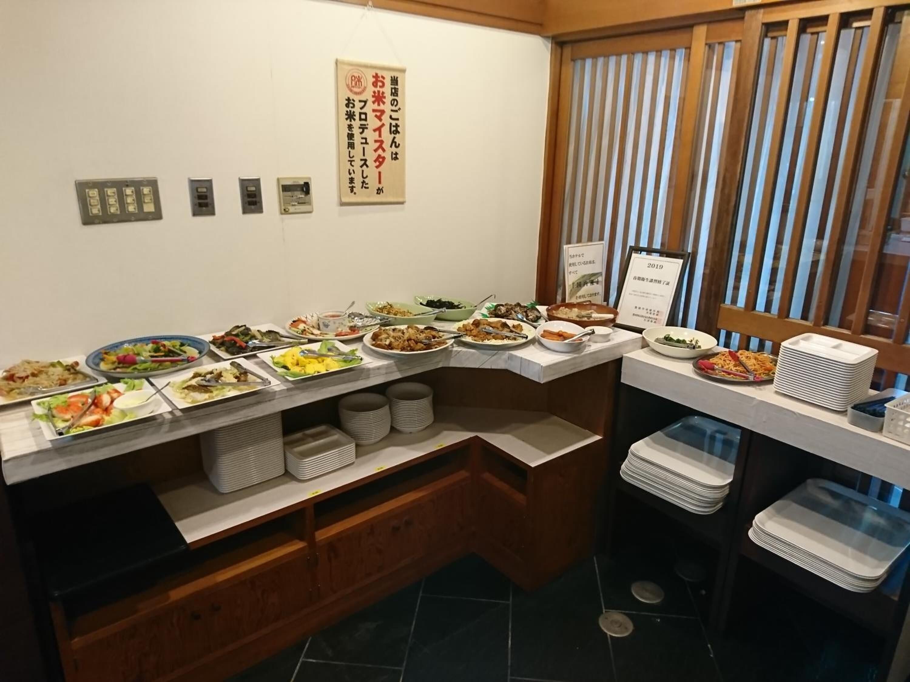 A buffet setup with various dishes and a sign indicating the year 2019.