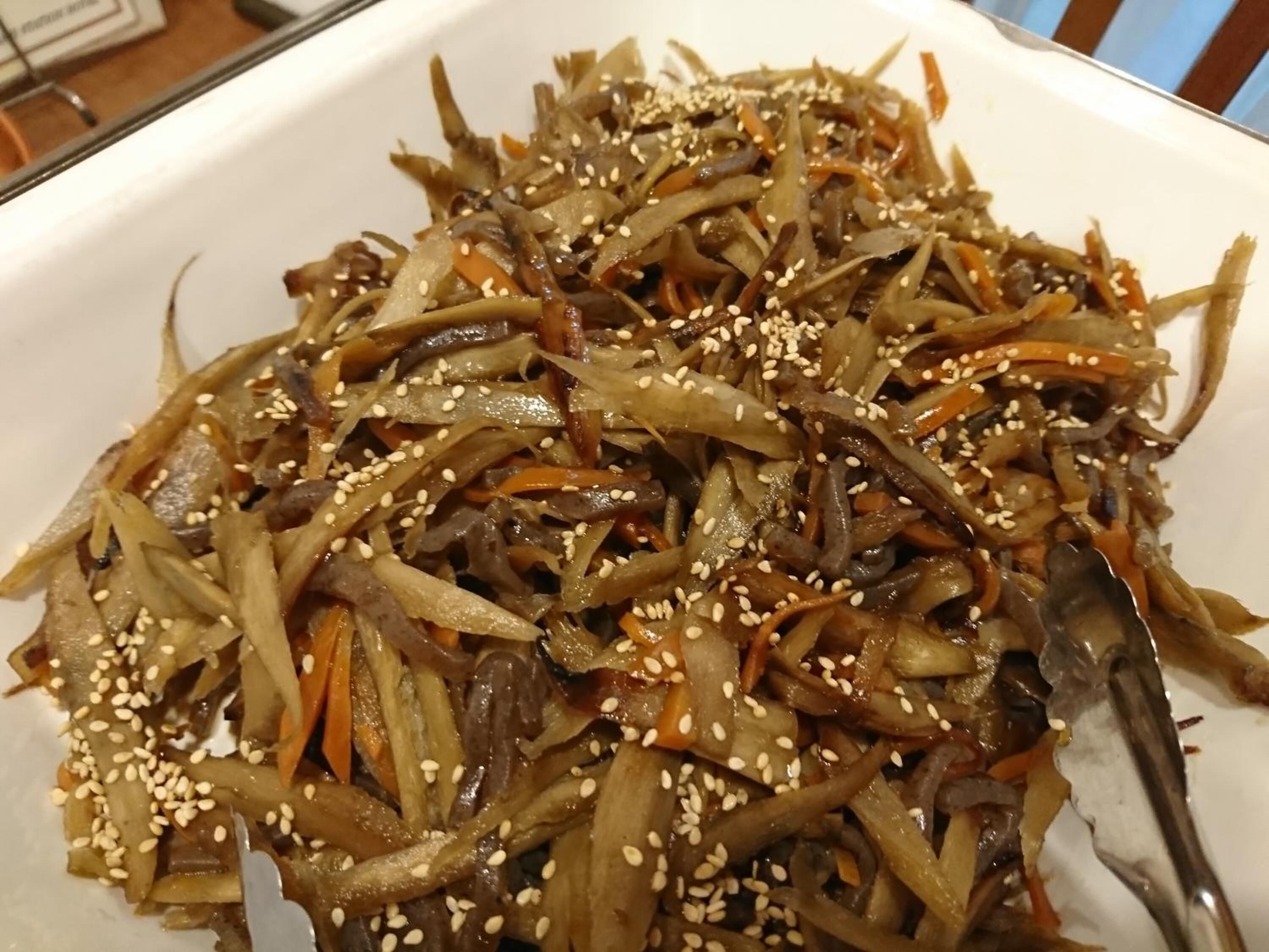 A plate of stir-fried vegetables with sesame seeds.