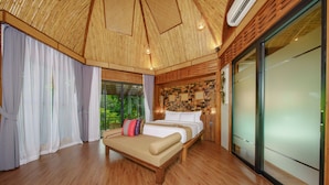 A spacious bedroom with a large bed, a wooden ceiling, and a view of greenery outside. - Aonang Fiore Resort (Krabi)