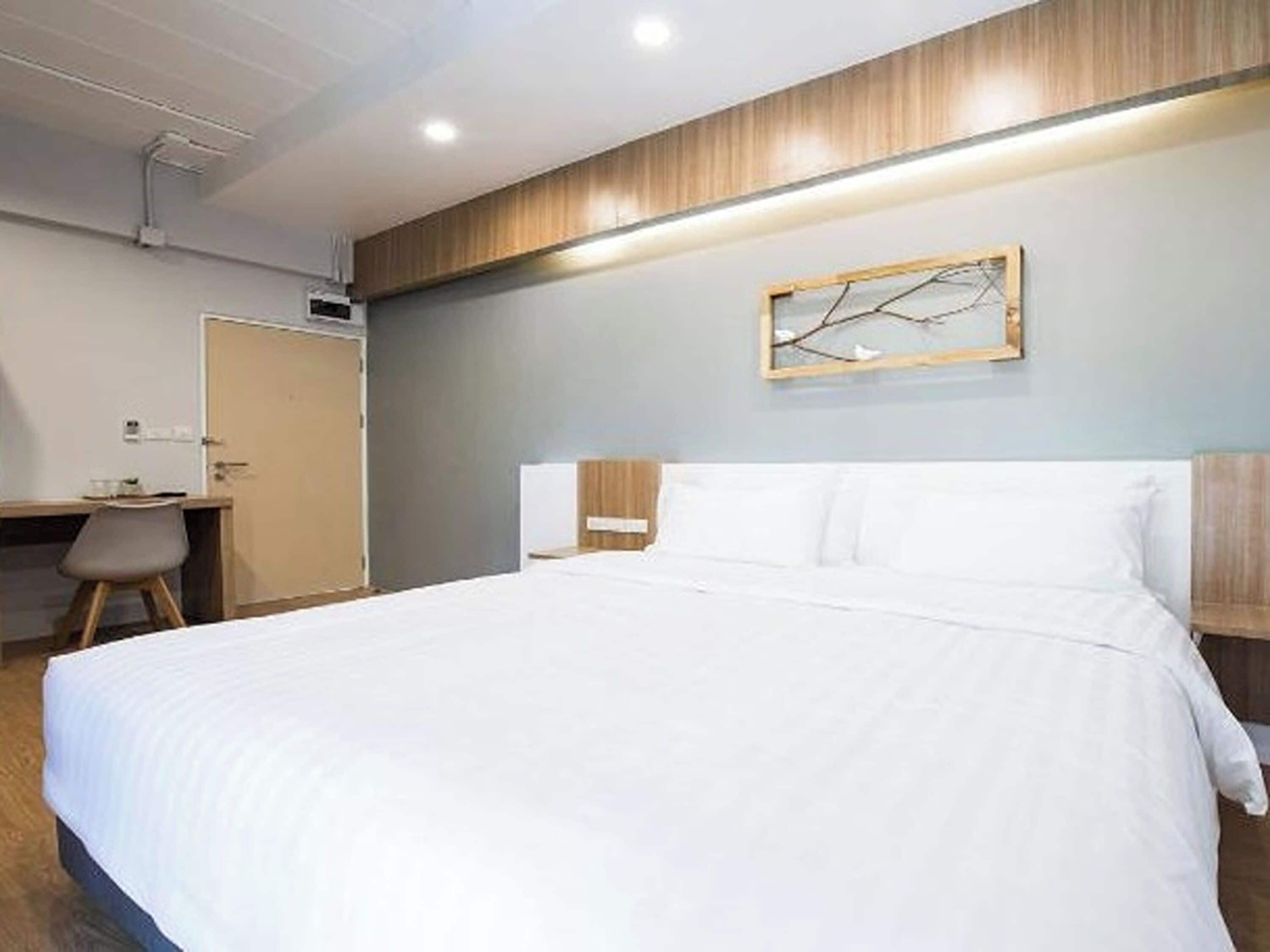 Ein Hotelzimmer mit einem Bett, einem Schreibtisch und einem Stuhl.