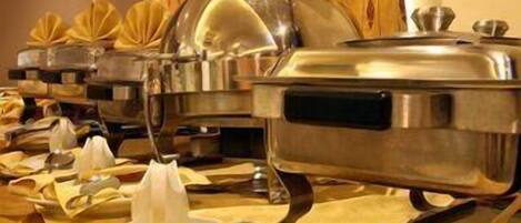 A buffet setup with multiple serving stations, each with a covered dish and a ladle.