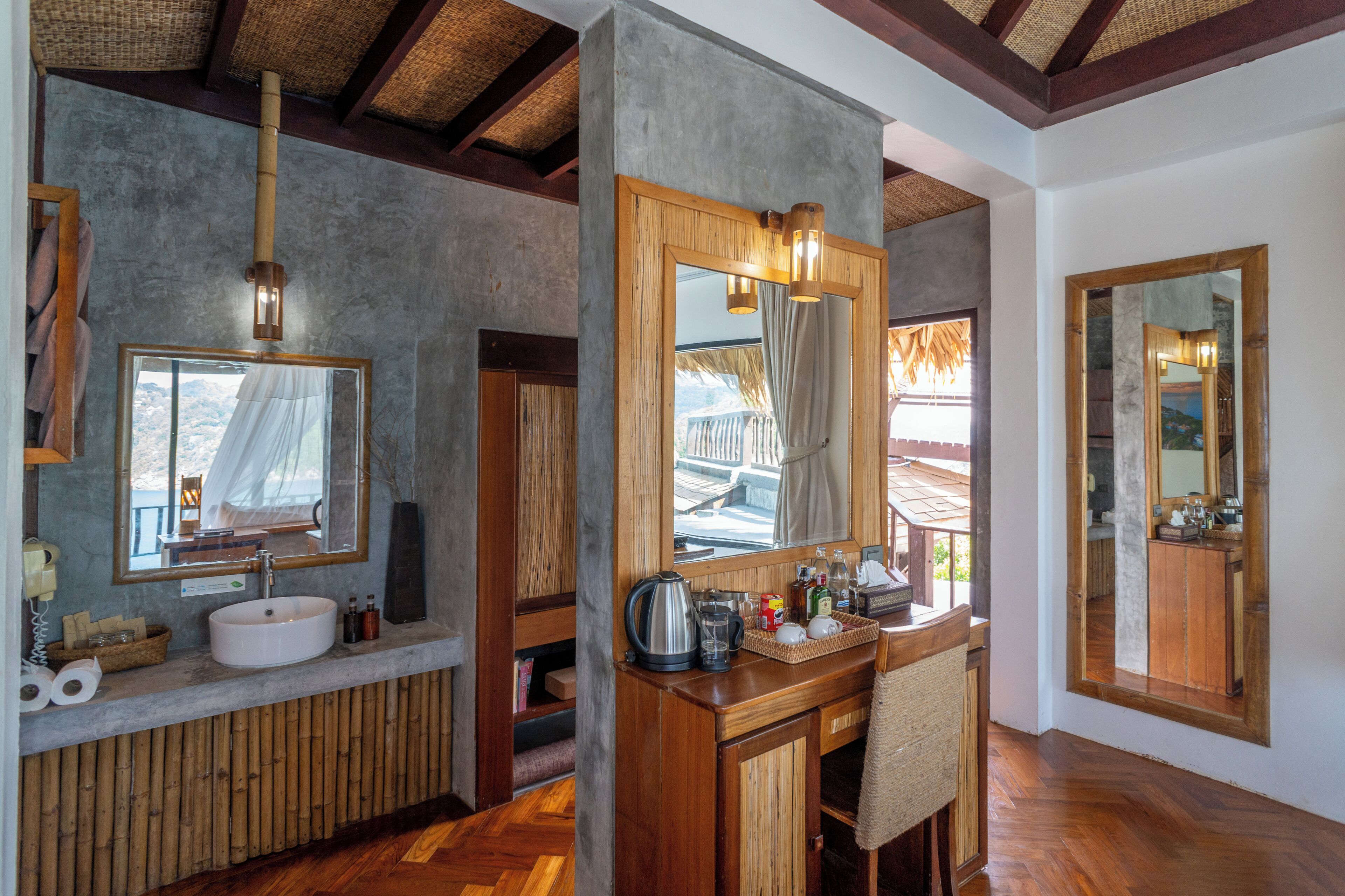 A bathroom with a wooden vanity, a sink, and a mirror.