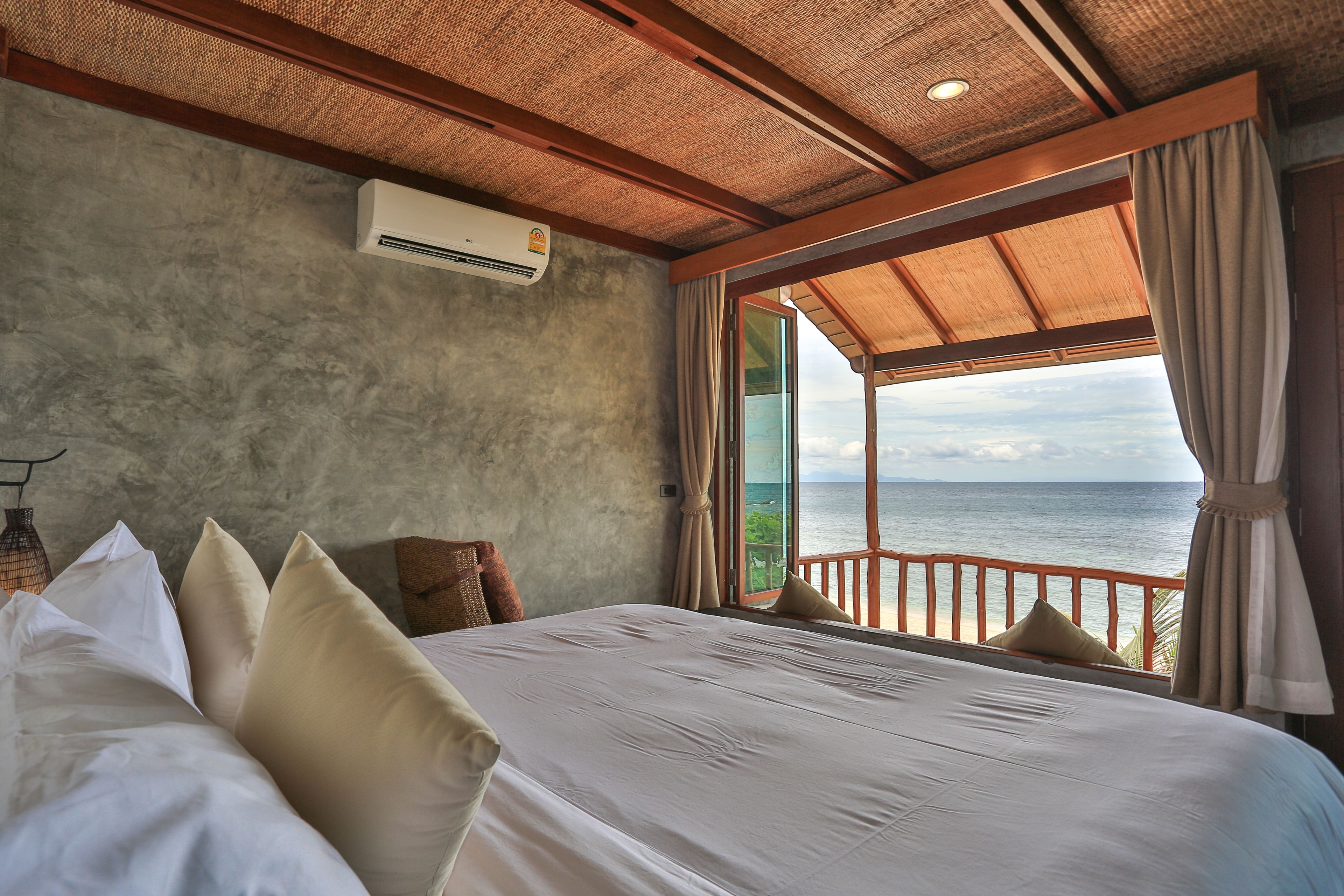 deluxe room, 1 king bed, beach view, beachfront | minibar, in-room safe, desk, laptop workspace