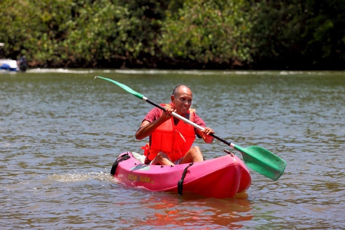A person kayaking on a body of water.