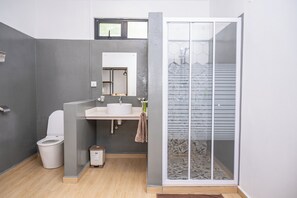 A modern bathroom with a toilet, sink, and shower. - EvaZion (Grand River South East)