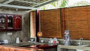 A kitchen with a wooden counter, a coffee maker, and a sink. - Colombo Beach Hostel (Mount Lavinia)