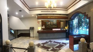 A hotel lobby with a reception desk, a chandelier, a checkered floor, and a staircase. - S.C. Heritage Hotel (Hat Yai)