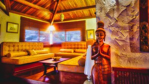 A room with a sofa set, a wooden coffee table, and a decorative lamp. - Ocean Beach Villa (Trou aux Biches)