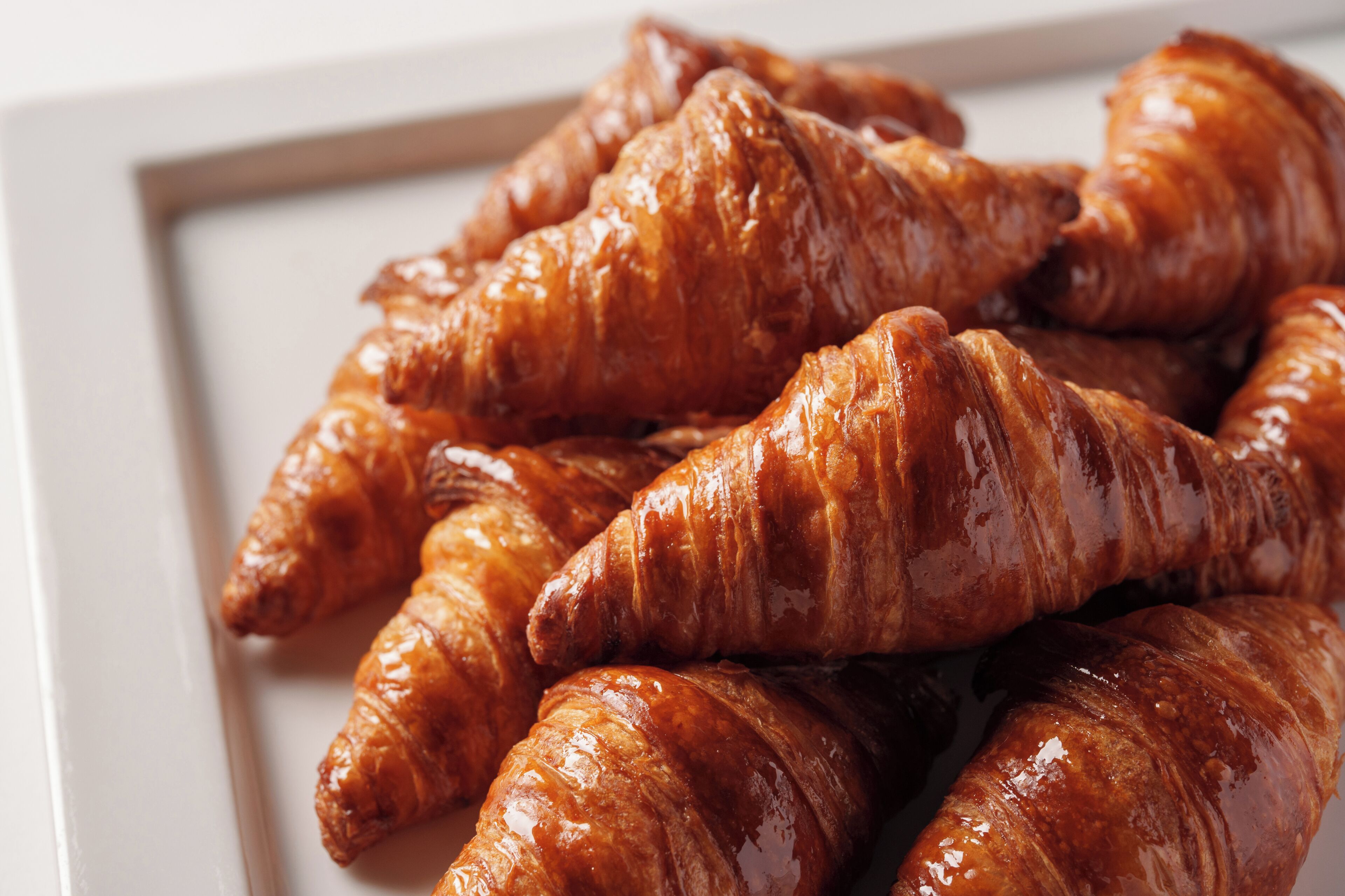 A close-up of glazed croissants.