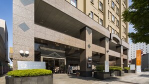 A hotel entrance with a sign reading "Premier Hotel Cabin." - Premier Hotel Cabin Obihiro (Obihiro)