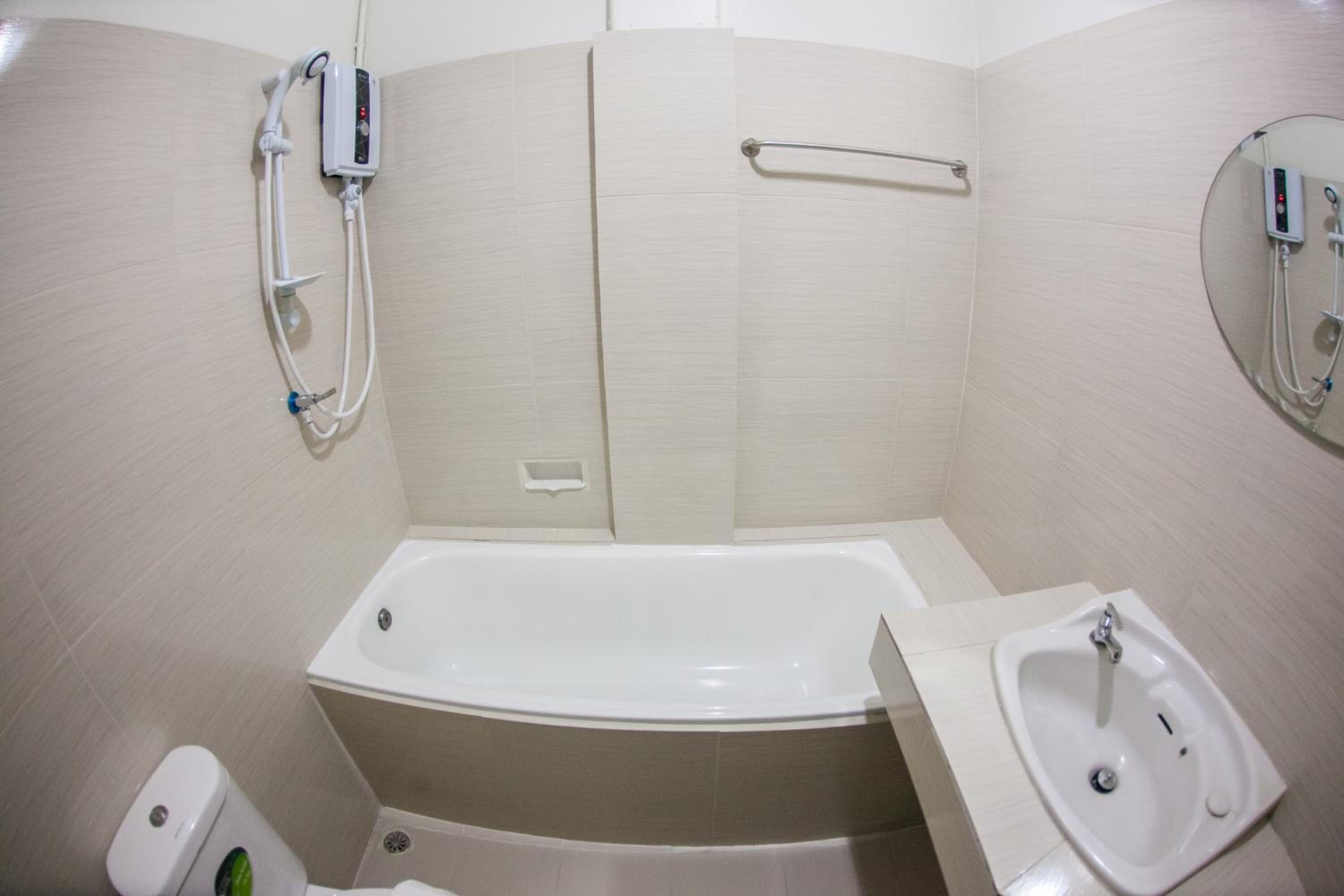 A bathroom with a bathtub, a sink, and a toilet.