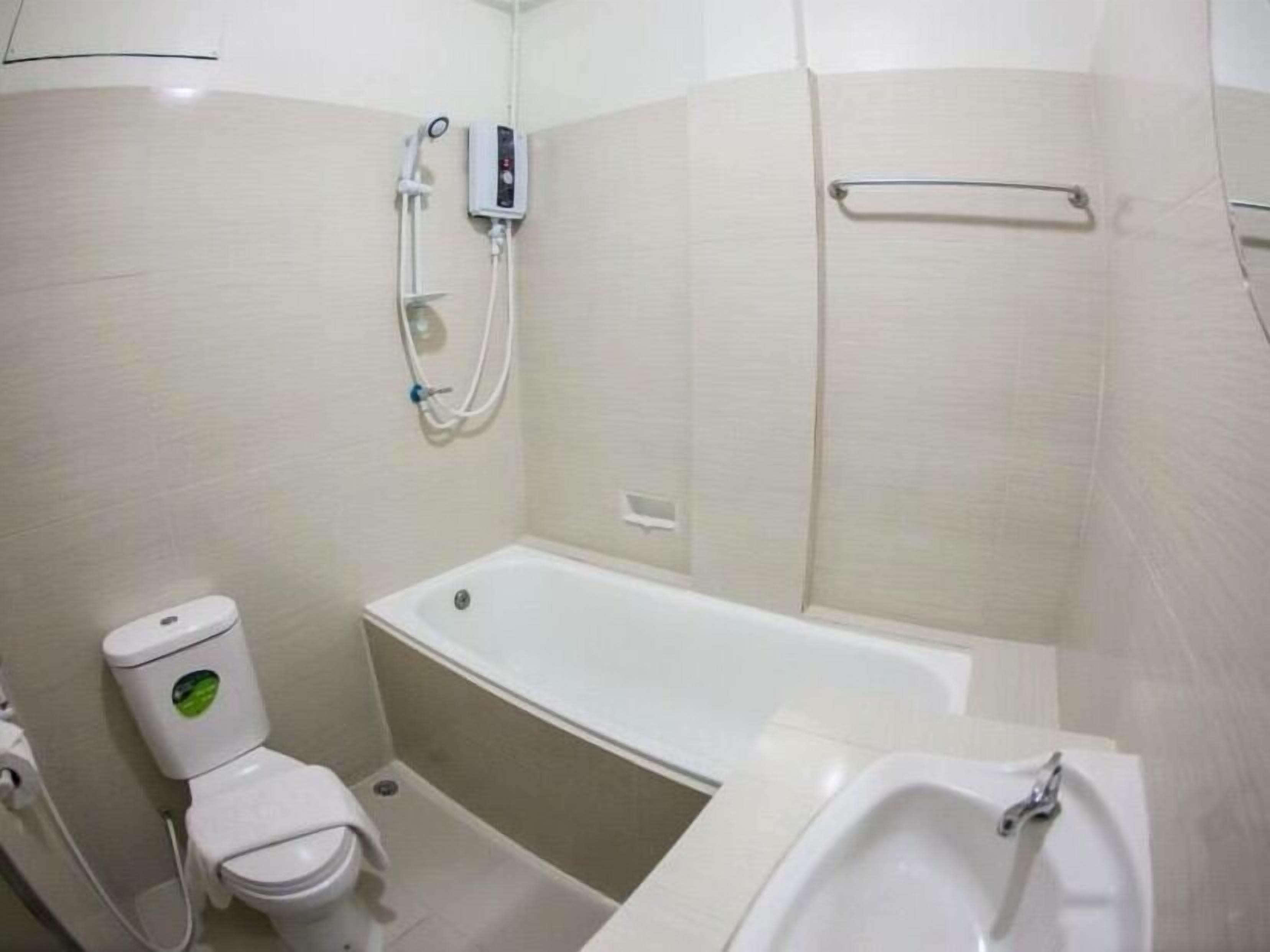 A small, clean bathroom with a toilet, a bathtub, and a sink.