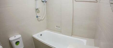 A small, clean bathroom with a toilet, a bathtub, and a sink.