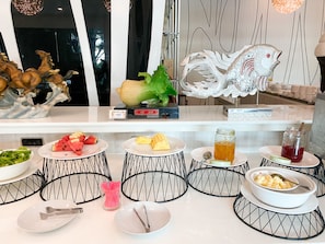 A buffet setup with various food items and decorative elements.