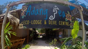 An entrance sign for Adang Sen Eco-Lodge & Dive Centre.