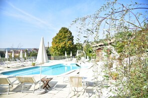Seasonal outdoor pool, open 9:00 AM to 7:00 PM, pool umbrellas