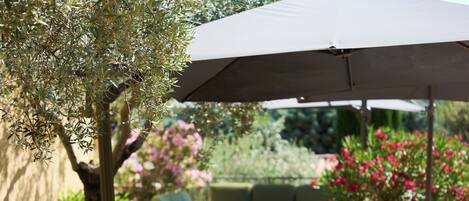 An outdoor seating area with chairs and a large umbrella.