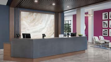 A modern reception desk with a marble wall, a digital screen, and a "Hilton" sign.